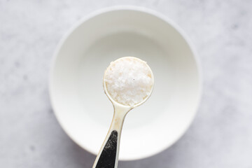 Overhead view of maldon salt in a teaspoon, a teaspoon of sea salt
