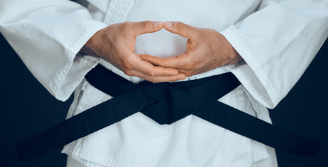 Karate, hands and black belt in studio for master, exercise and training in fighting. Person,...