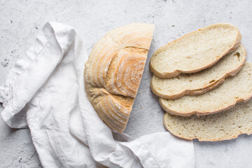 Overhead view of sliced homemade artisan bread on parchment paper, top view of baked sourdough artisan bread slices