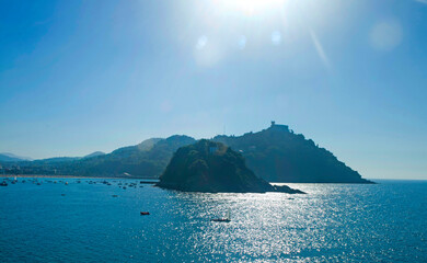 view of Santa Clara and Mount Igueldo in La Concha Bay in the city of San Sebastián