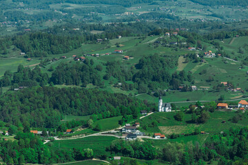 Slovenian countryside viewed from stolp ljubezni or tower of love, wooden lookout close to Sentjur pri Celju. Sunny day, green hills and forests in slovenia