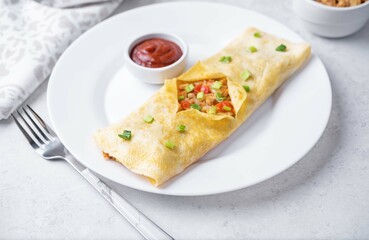 Spicy ground pork stuffed omelette with rice and tomato sauce in a plate, kai yat sat