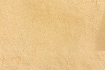 pattern of textured plaster wall in yellow