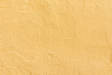 pattern of textured plaster wall in yellow
