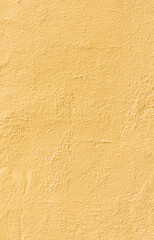 pattern of textured plaster wall in yellow