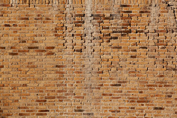 Stone texture of a wall in Montenegro. An ancient wall made of brown coloured stones. Background. Template. For design. Horizontal.