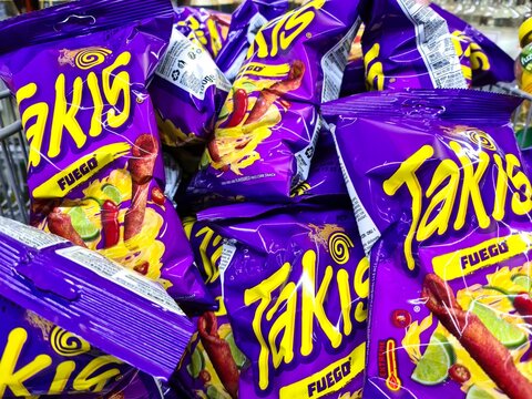 Kiel, Germany - 23.May 2024: Several purple bags of Takis brand hot chips in a supermarket.