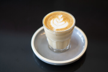 Glass of hot drink with frothy art