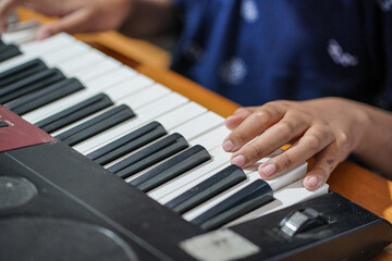 Close up image of a hand playing the piano