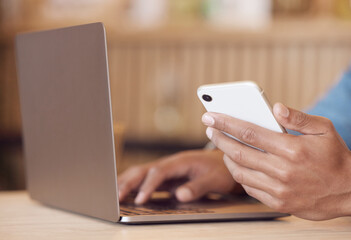 Man, hand and smartphone or working with laptop, typing and freelancer in internet cafe for research or text. Browse, networking and coffee shop for remote job on website, social media and scrolling