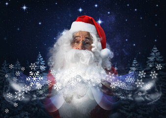Santa Claus blowing snow in winter forest. Christmas magic