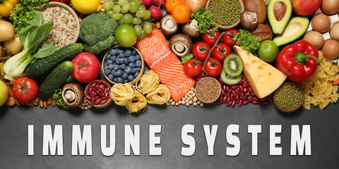 Immune system boosting with proper nutrition. Different foods on black table, flat lay. Banner...