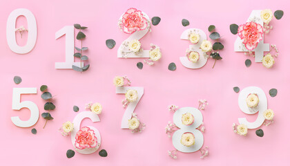 Numbers and beautiful flowers on pink background, top view. Banner design