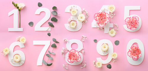 Numbers and beautiful flowers on pink background, top view. Banner design