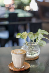 A glass of coffee with latte art on the table