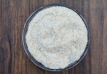 Psyllium husk or isabgol husk in a plate on wooden background top view 