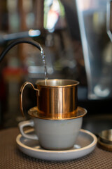 Pouring hot water to make Vietnam drip manual brew coffee