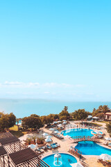 Dead Sea on the border of Jordan and Israel - View of the sea from the luxury resort pools. Copy...