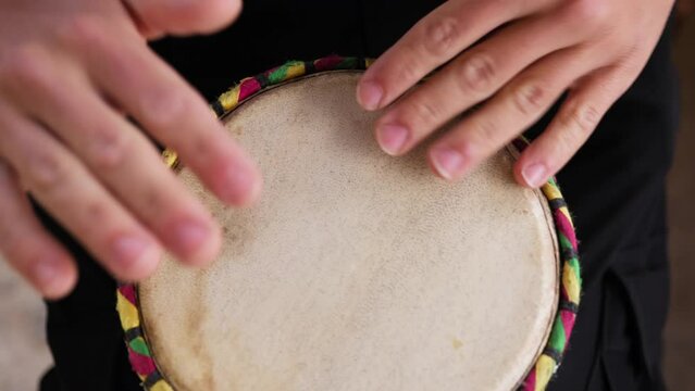 Hands Of A Musician Playing A Drum Between His Legs In Calabria