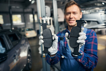 Close up photo of male holding vehicle pads