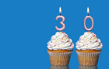 Birthday Cupcakes With Candles Lit Forming The Number 30