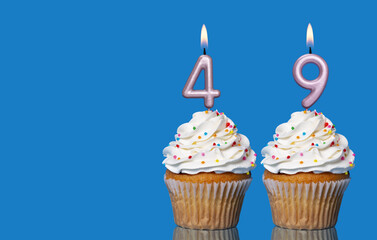 Birthday Cupcakes With Candles Lit Forming The Number 49