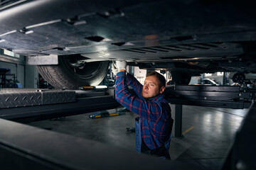 Professional mechanic examine car, working in tire fitting