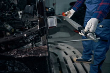 Male installing ruler on body of car