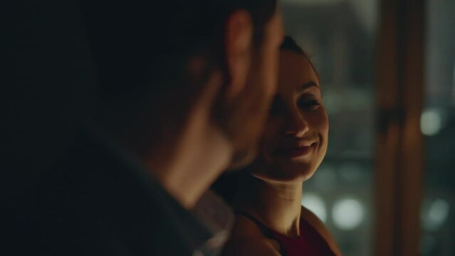 Woman looking night window closeup. Romantic man joining beloved wife embracing