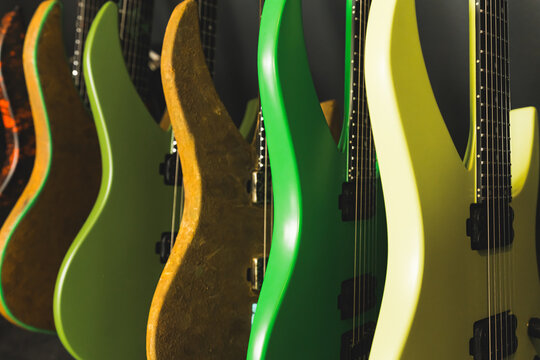 closeup of green and yellow guitars in the studio, a collection of electric guitars at the recording studio. High quality photo