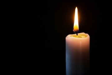 Burning candle on a dark background