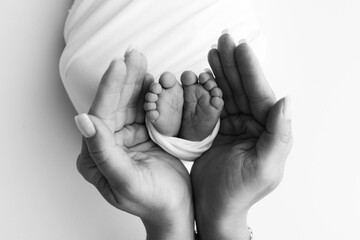 The palms of the father, the mother are holding the foot of the newborn baby. Feet of the newborn...