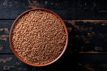 Dry Buckwheat Groats on Dark Wooden Background, Top View, Copy Space
