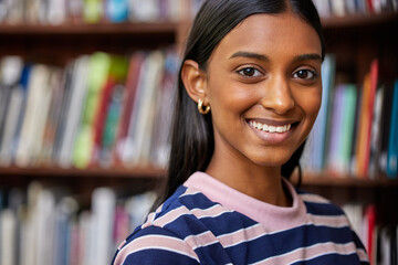 University, books and portrait of Indian woman in library for research, studying and learning. Education, college and happy student with textbooks for knowledge, information and literature project