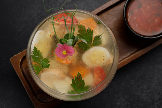 Jellied meat with quail eggs in a glass bowl