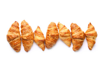 Many tasty croissants on white background