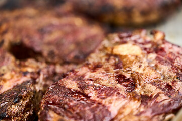 The ruddy texture of juicy Black Angus steaks cooked on the grill. Close-up