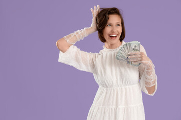 Happy young woman with money on lilac background