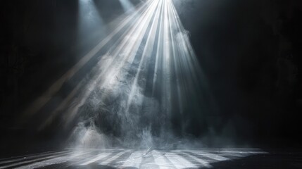 A dramatic beam of light cutting through the darkness, drawing focus to a key moment on stage