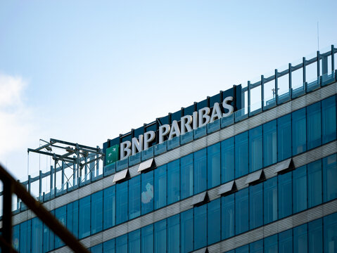 BERLIN, GERMANY - 30. April 2024: BNP Paribas bank logo sign on a building in the capital city. Exterior of a modern office complex with a glass facade. Multinational company and big employer.