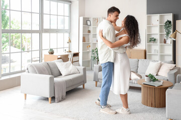 Young couple in love dancing at home