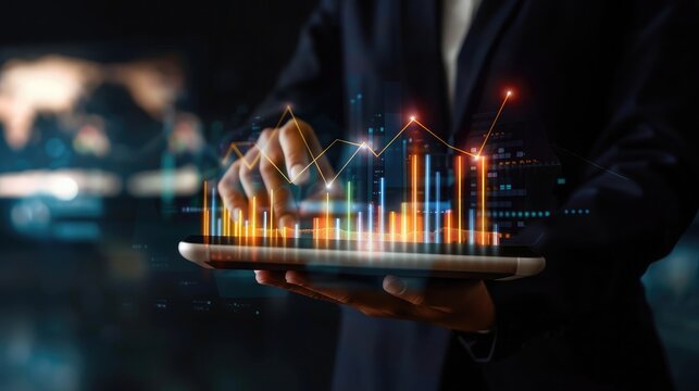 Businessperson holding a tablet with overlapping graphs displayed, symbolizing digital finance and modern business solutions