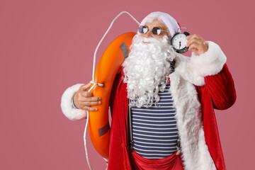 Santa Claus with ring buoy on pink background. Christmas in July