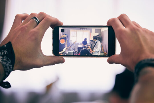 Recording, smartphone and garage band playing live music for internet concert, streaming or social media post. People, mobile and instruments together for creative event or online festival audition
