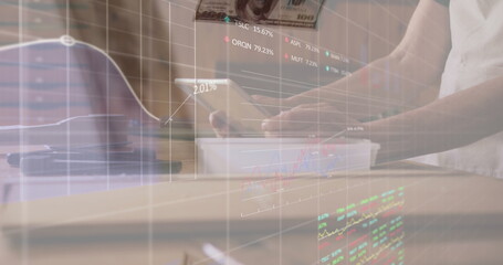 Image of data processing over hands using tablet