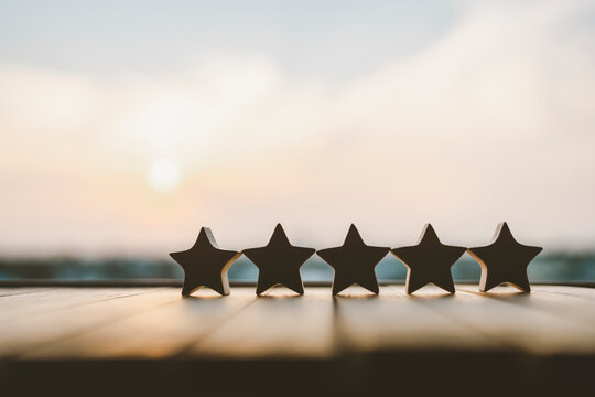 Five star shape on wood table. The best excellent business services rating customer experience concept.	