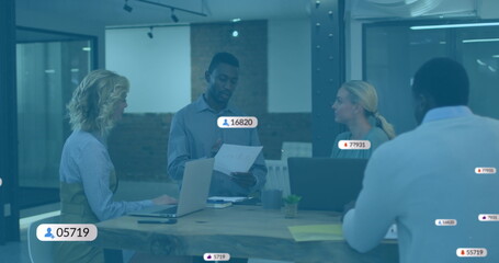 Image of social media icons with numbers over diverse business people having meeting at office