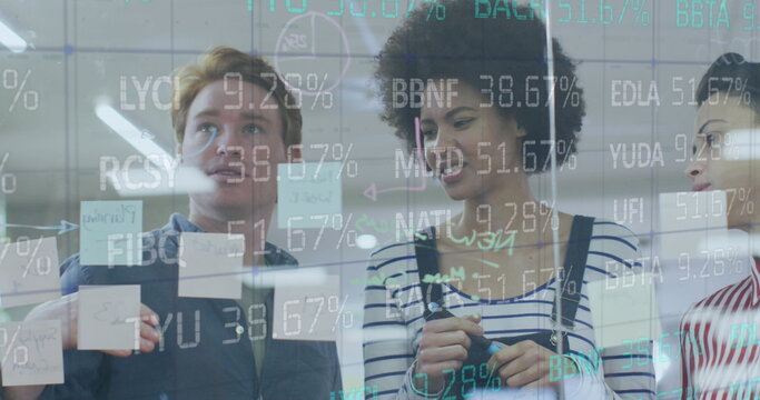 Image of financial data processing over diverse colleagues discussing over glass board at office