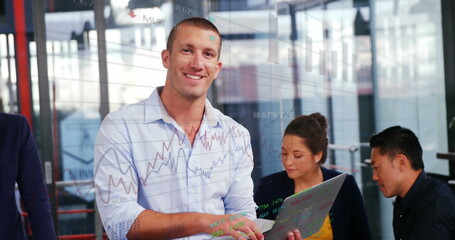 Image of statistical and stock market data processing over caucasian man using laptop at office