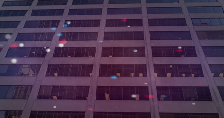 Image of red blue and white spots over building